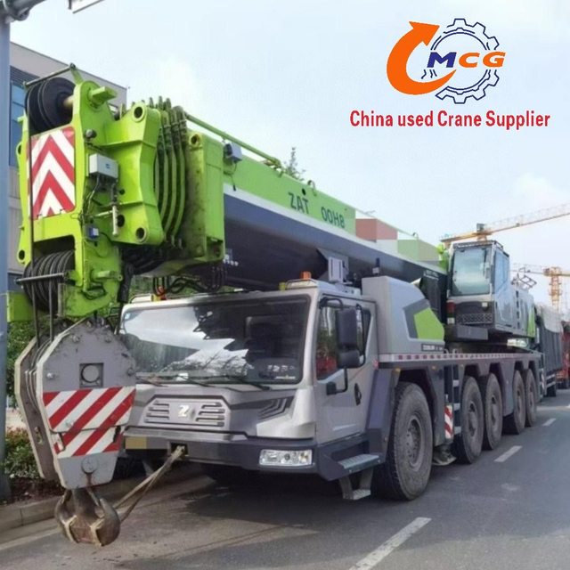 A used 2021 Zoomlion 220-ton, 8-section boom ZAT2200H8 truck crane in excellent condition, suitable for all heavy construction machinery applications.