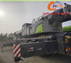 A used 2021 Zoomlion 220-ton, 8-section boom ZAT2200H8 truck crane in excellent condition, suitable for all heavy construction machinery applications.